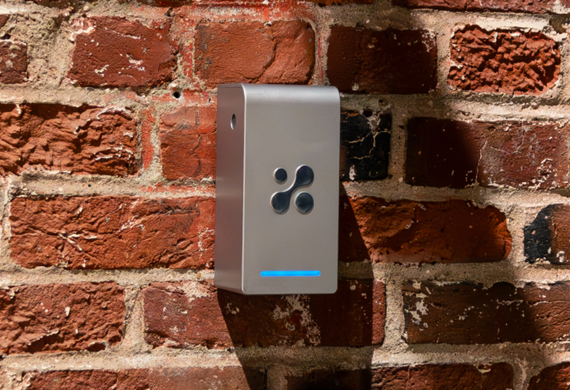 Aethair PRO mounted to a brick wall, monitoring the real-time air quality and environmental conditions.
