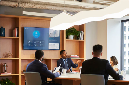 Aethair dashboard displayed on a TV in a modern conference room during a meeting.