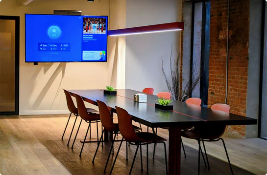 Aethair dashboard displayed on a TV in a modern conference room.