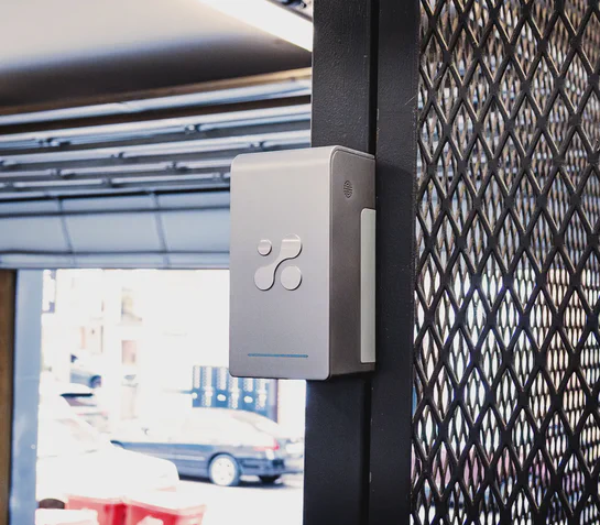 Aethair PRO mounted to a metal cage in an industrial garage setting.