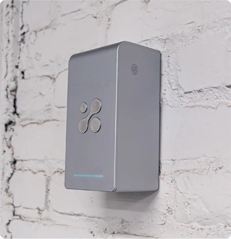 Aethair PRO mounted to a white brick wall.