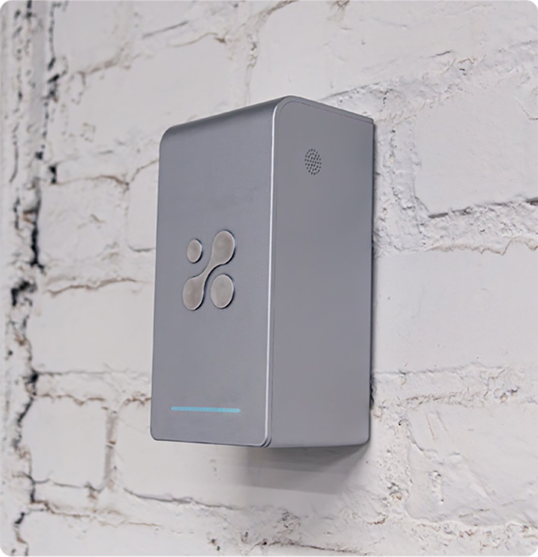 Aethair PRO mounted to a white brick wall.