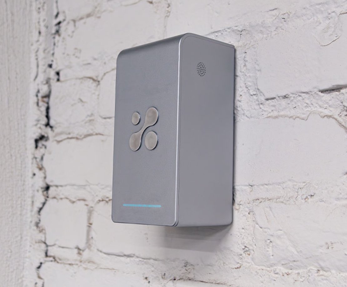 Aethair PRO mounted to a white brick wall.