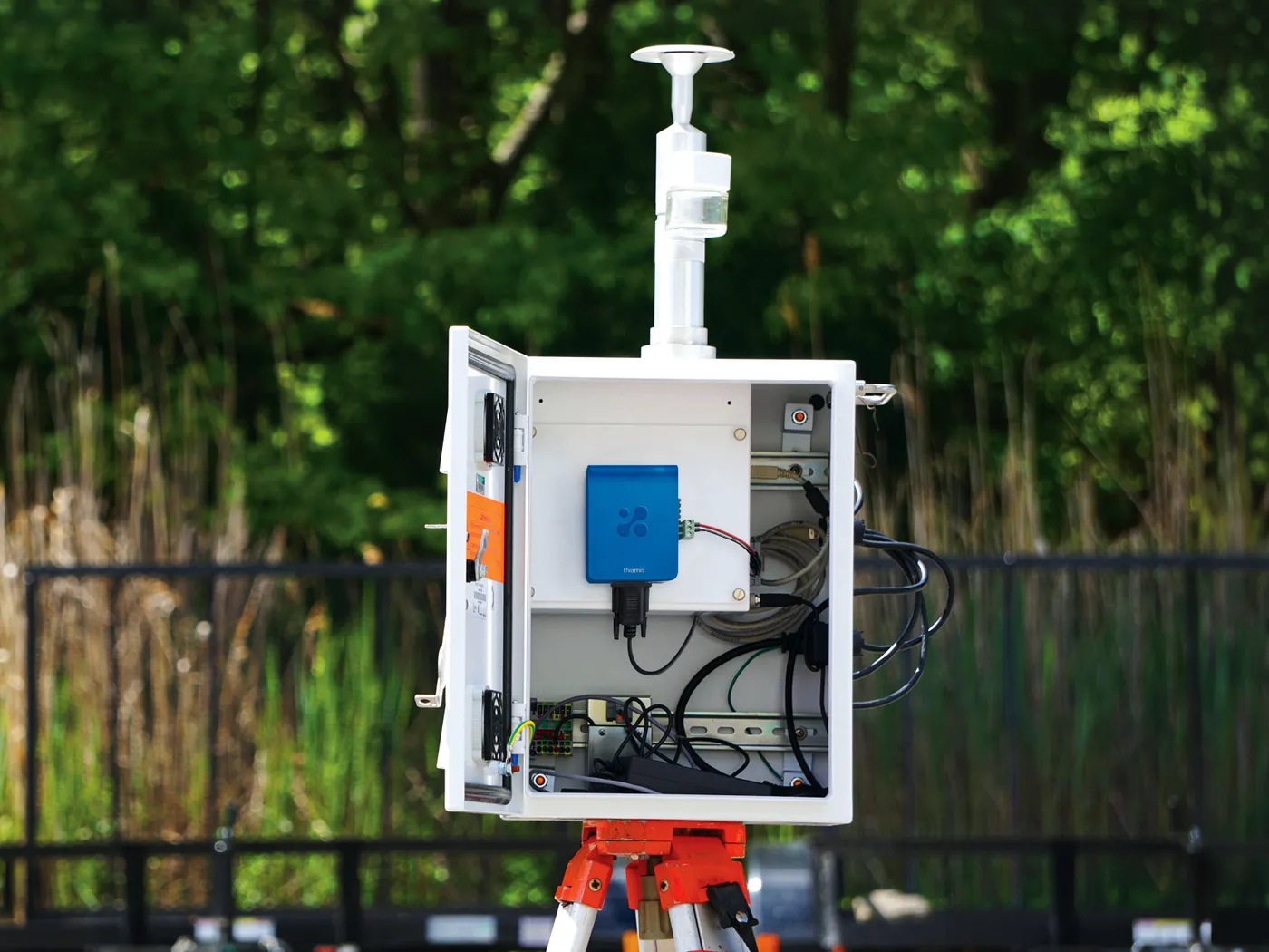 Aethair Thiamis connected to a TSI DustTrak PM monitor inside a weatherproof box with a heated inlet.