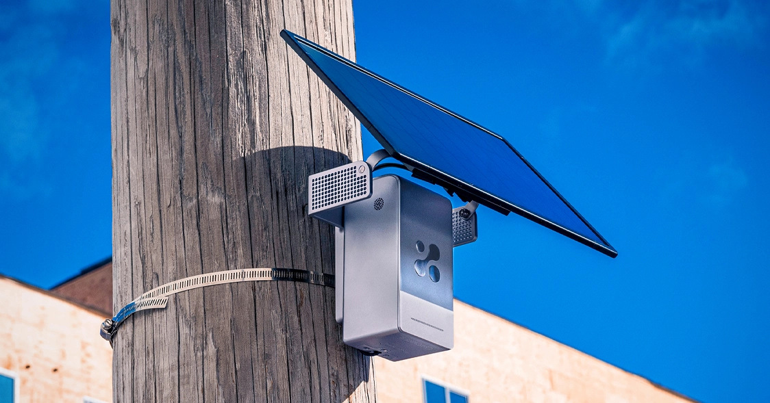 An Aethair PRO air quality monitor mounted outdoors with a solar panel, running on 4G LTE for off-grid fenceline monitoring
