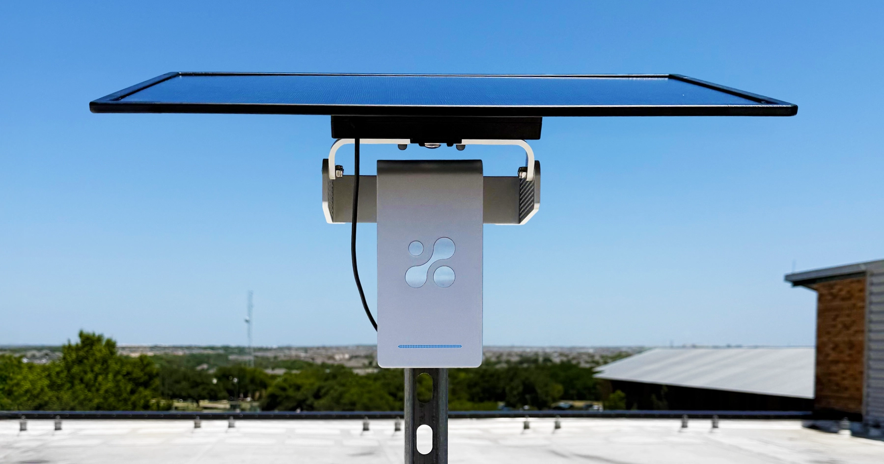 Aethair PRO outdoor air quality monitor mounted on a rooftop pole