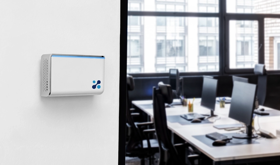 Aethair IAQ mounted to a wall near the doorway to an office