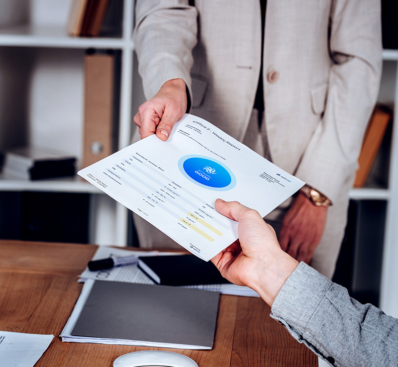 Office workers handing off an Aethair Air Quality Report