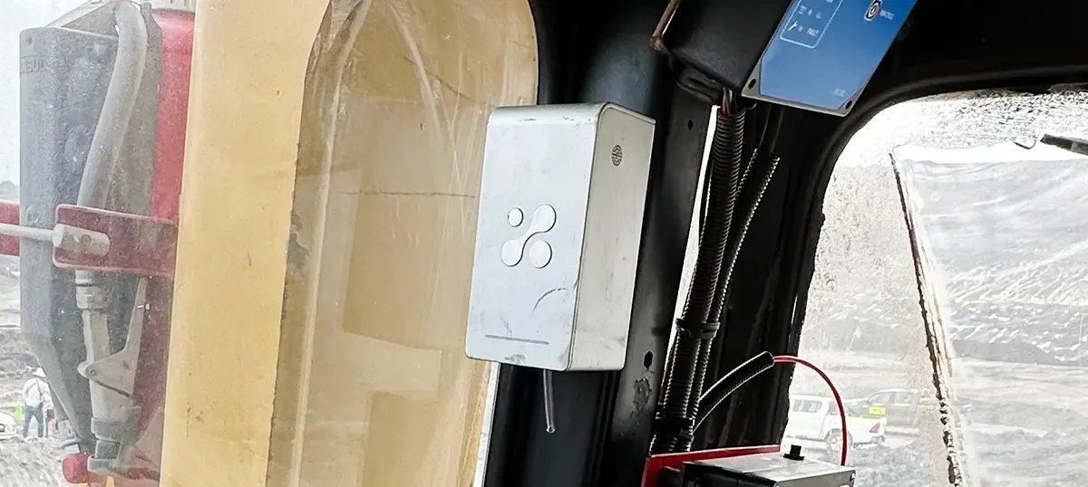 An Aethair PRO mounted inside the operator cab of a mining machine, beside the window.
