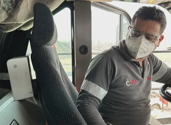 Mining equipment operator seated in heavy equipment looking at an Aethair PRO mounted beside the seat.