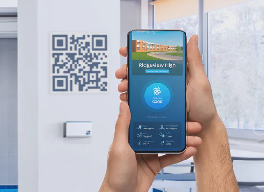A QR code at a school that opens a live Aethair air quality dashboard on a phone.