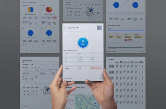 Hands holding an Aethair air quality report with additional report pages in the background.