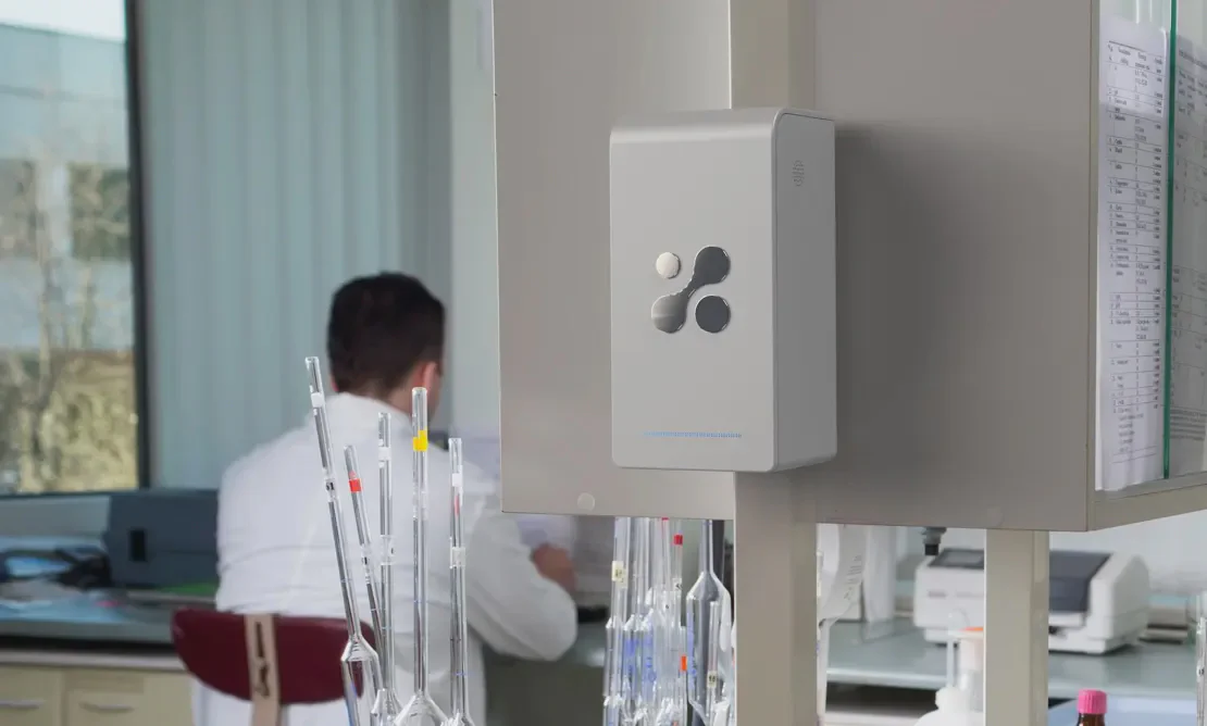 Aethair PRO deployed in a medical laboratory with a researcher working in the background.