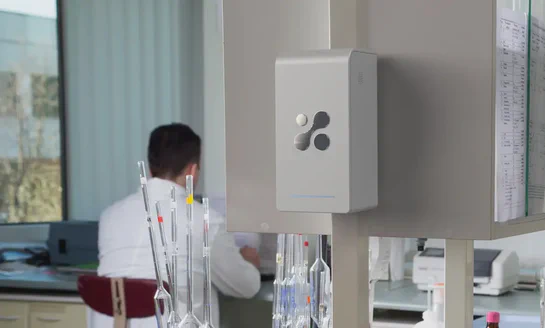 Aethair PRO deployed in a medical laboratory with a researcher working in the background.